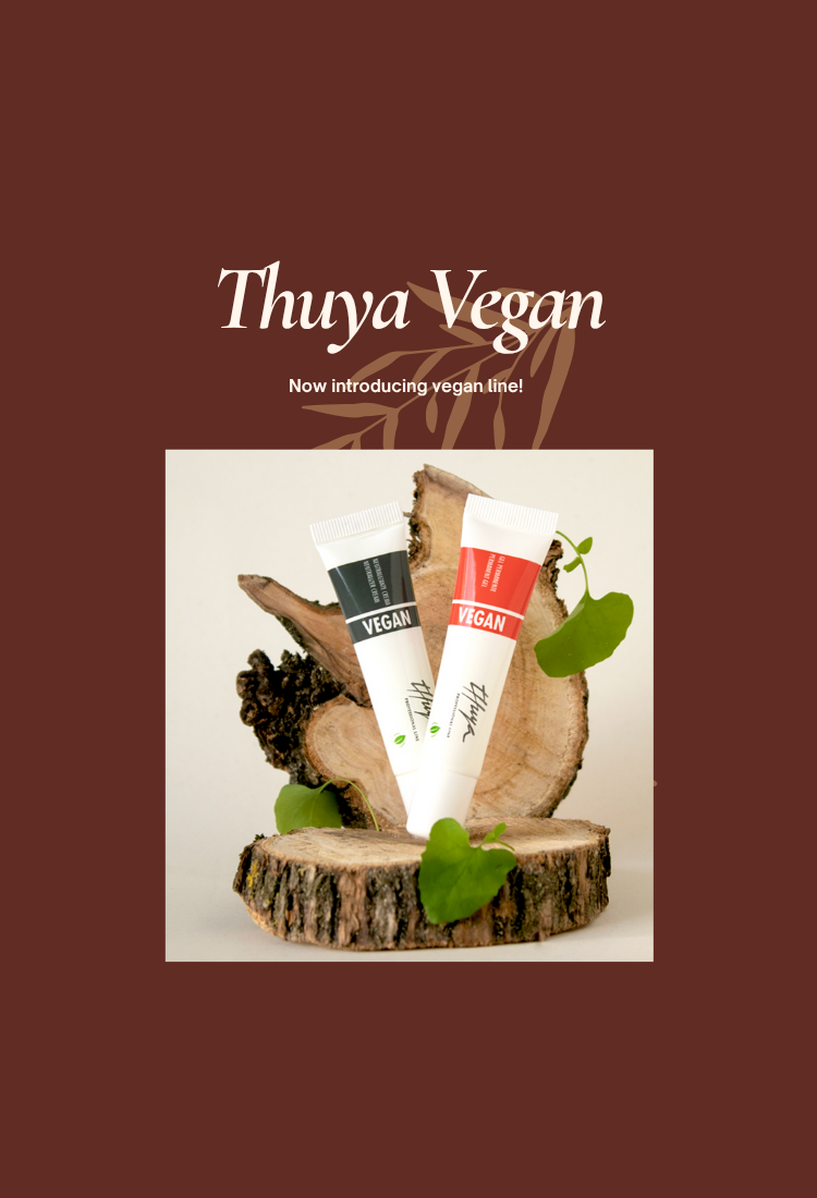 Advertisement for Thuya Vegan with skincare products on a wooden stump against a brown background.